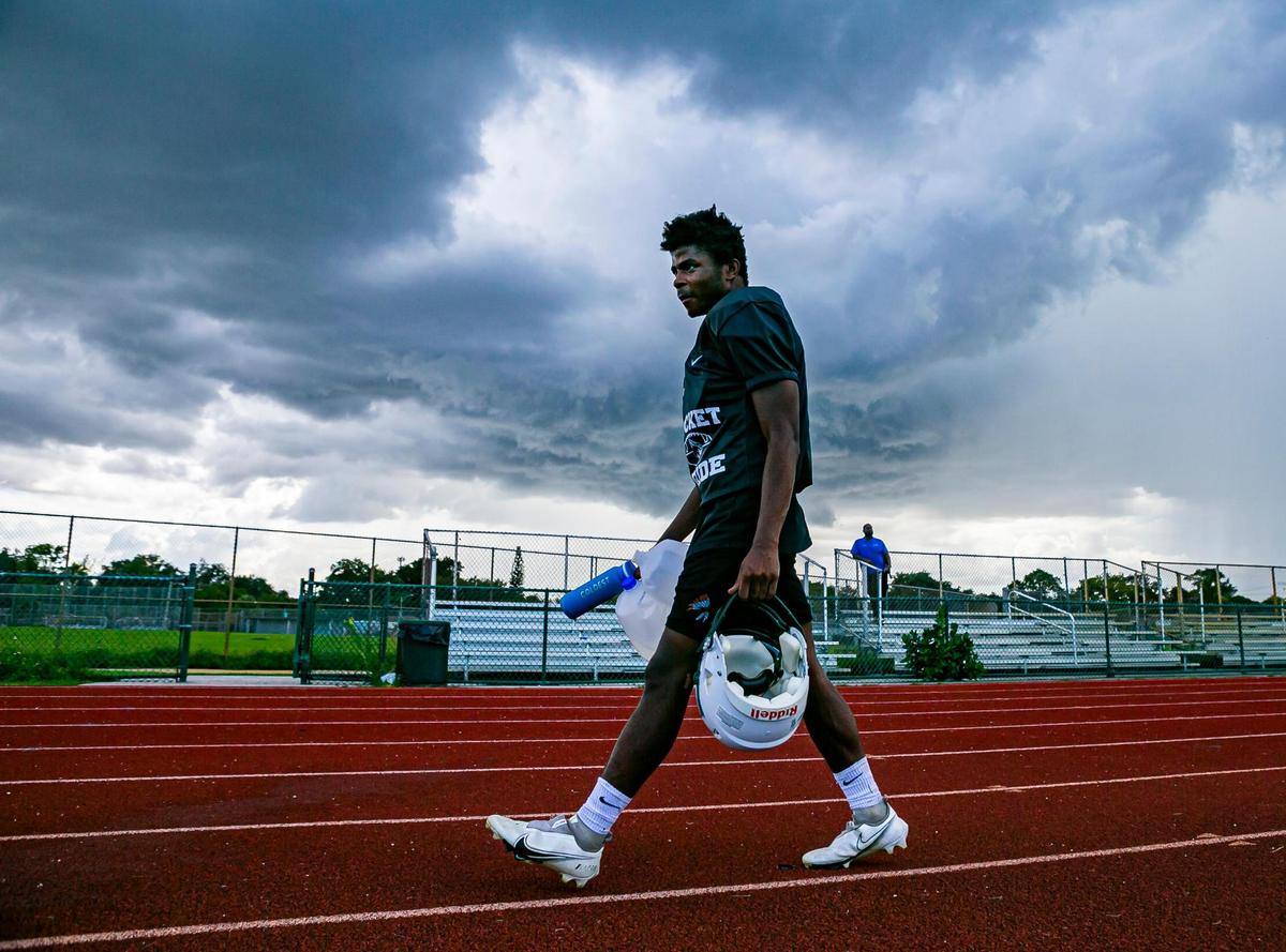 Miami Central football player Antwan Sheppard walks back to the locker room after a lightning alarm temporary suspended a preseason practice at his school’s field in Miami’s West Little River neighborhood on Thursday, August 5, 2021.