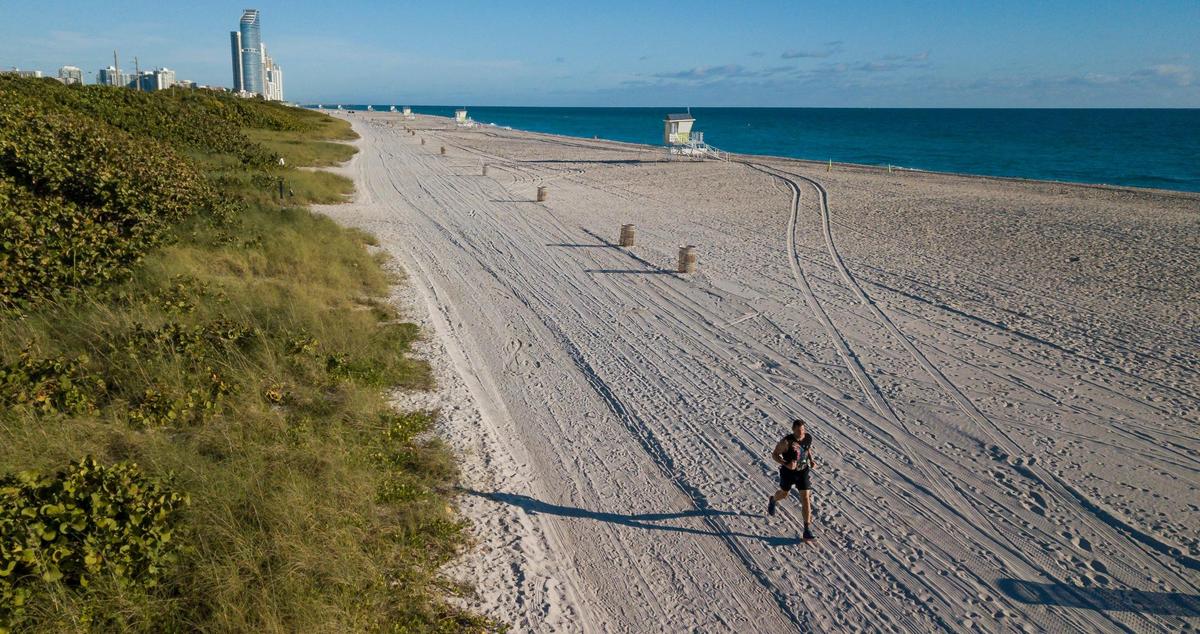 Mika Shevit, 48, who will be running in the half-marathon portion of this year’s Miami Marathon, jogs through Haulover Beach on Thursday, Jan. 19, 2023 in Miami Beach, Fla. Shevit has been running a half marathon for more than 650 days consecutively and is looking to reach at least a 1000-day streak.