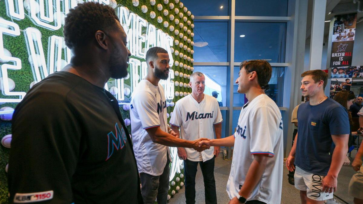Miami Marlins pitcher Sandy Alcantara, joined by former Miami Marlins players Jeff Conine and Charles Johnson, greet baseball fans during the Miami Marlins FanFest event at loanDepot park in Miami, Florida on Saturday, February 11, 2023.