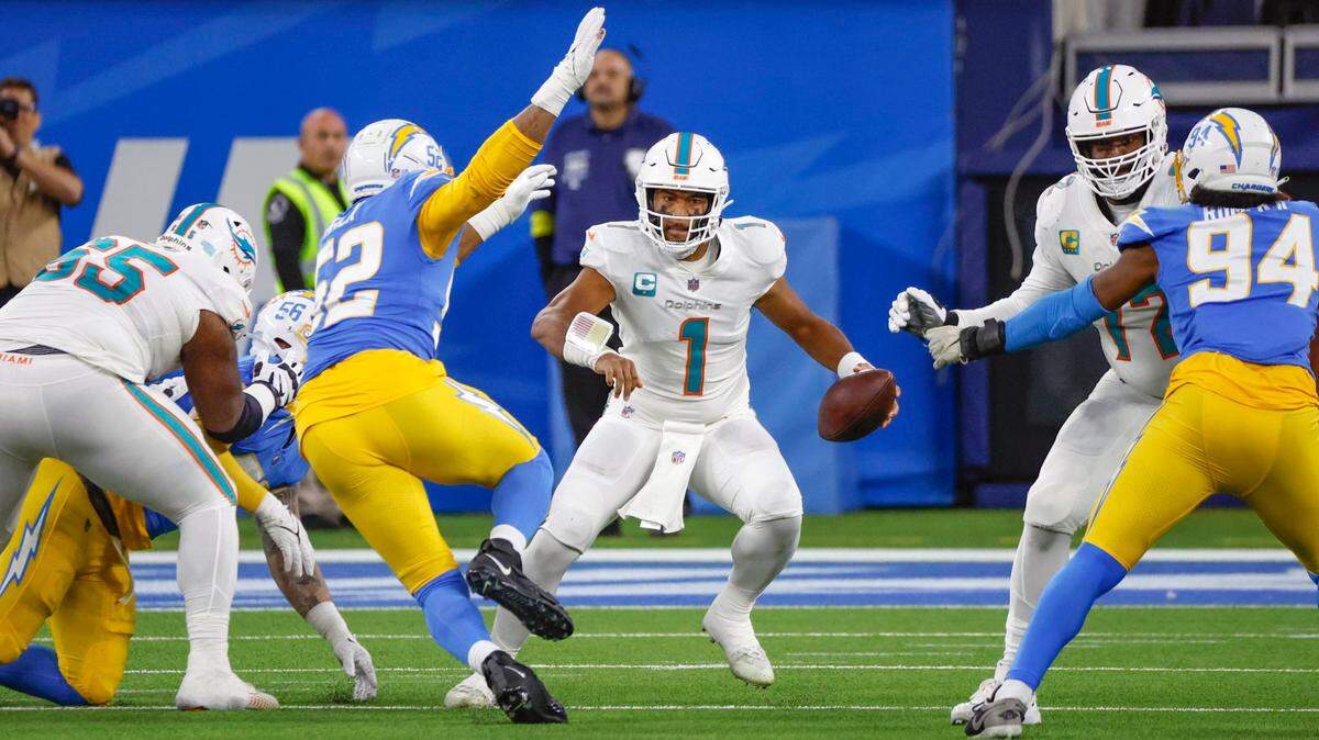 Miami Dolphins quarterback Tua Tagovailoa (1) scrambles during the game against the Los Angeles Chargers in the second quarter at SoFi Stadium in Inglewood, California on Sunday, December 11, 2022.