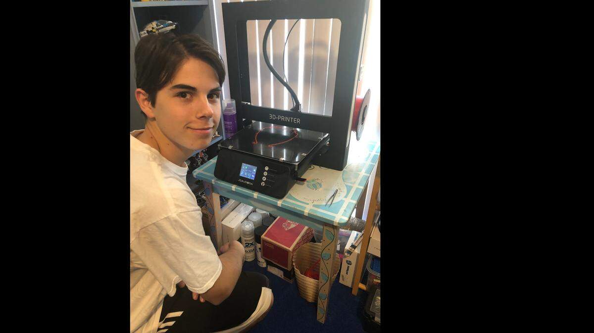 David Tamen, a 16-year-old sophomore and build leader for the robotics team at Miami Beach Senior High, prints plastic headbands for his homemade face shields used for the coronavirus pandemic.