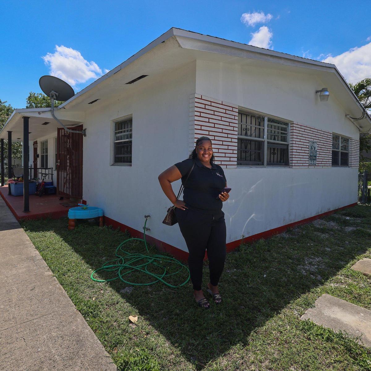 Sabrina Guillaume stands outside the duplex she owns in Liberty City. Guillaume spent several years trying to buy a property in the neighborhood where her parents live and she grew up.