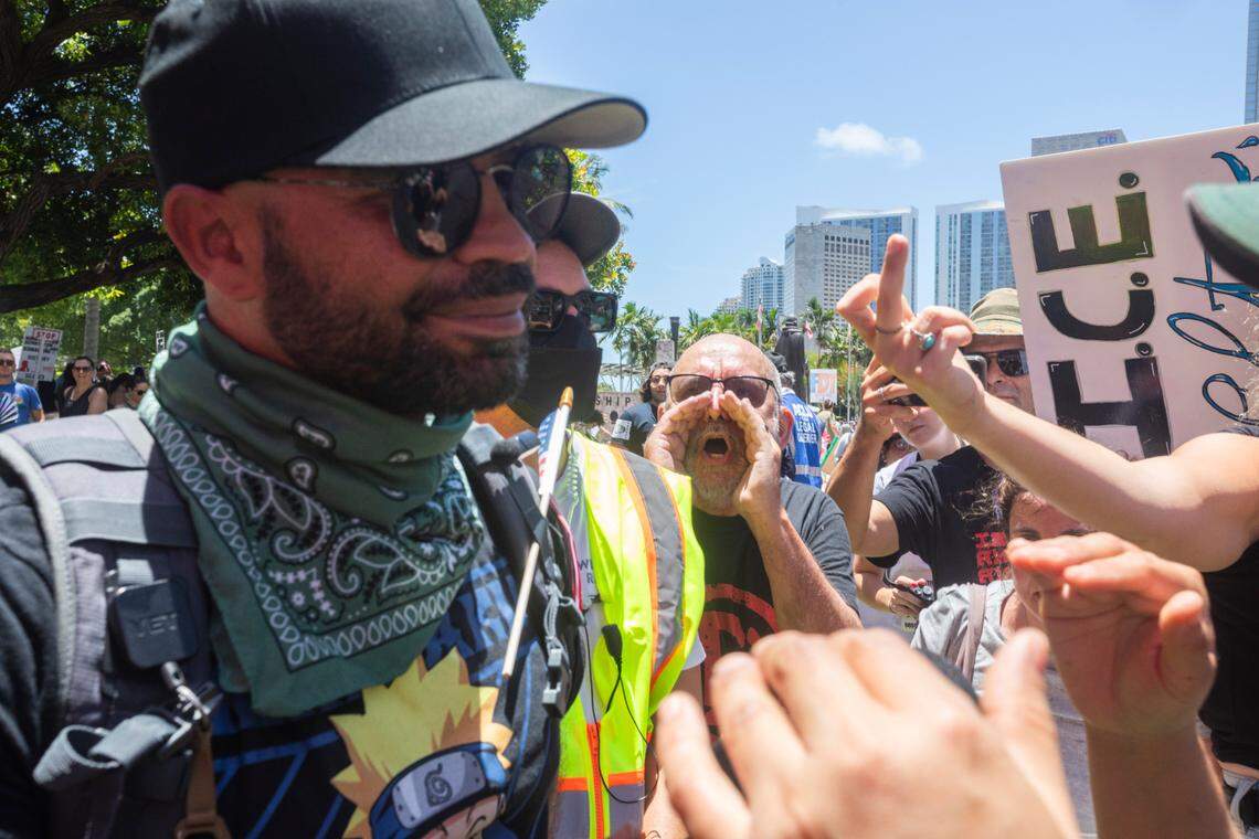 Enrique Tarrio, left, turned up at the ‘No Kings’ protest at the Torch of Friendship monument at Bayfront Park in Miami, Florida, on June 14, 2025. Some protesters extended the middle finger and shouted their disapproval at the former Proud Boys leader. Tarrio was pardoned by President Donald Trump for his role in the attack on the nation’s Capitol on Jan. 6, 2021.
