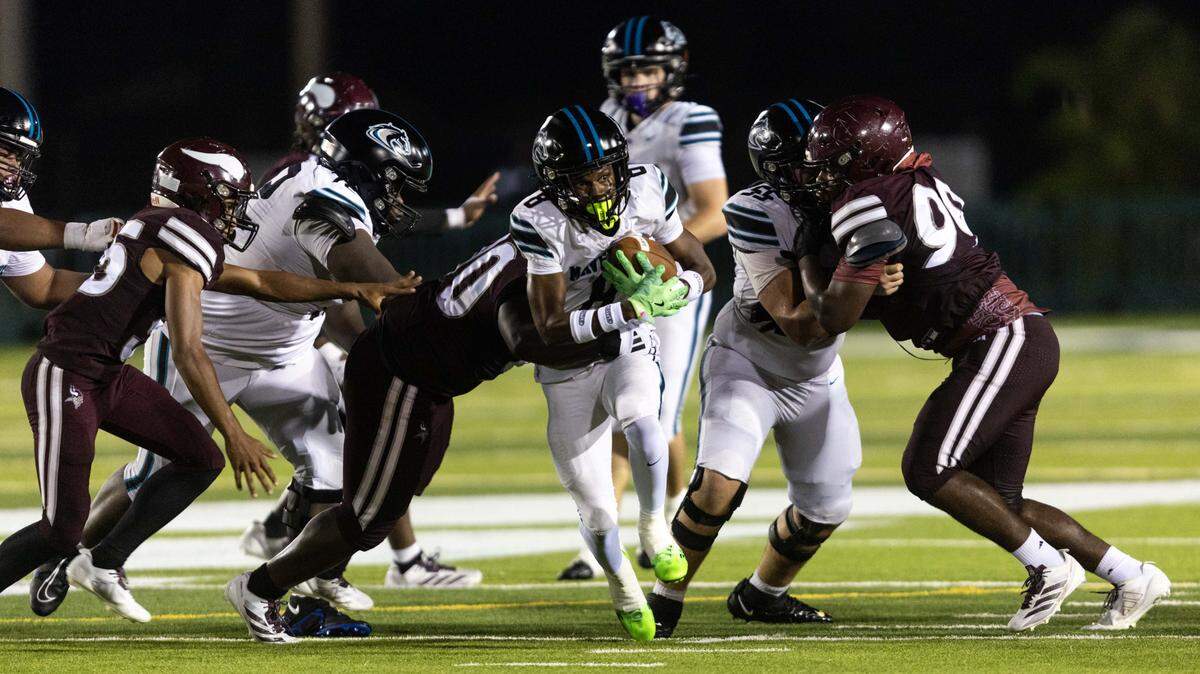 Archbishop McCarthy Mavericks running back Jeremiah Alexandre (8) is tackled by Miami Norland defensive tackle Justice Rivera (90) during a high school football game at Traz Powell Stadium on Thursday, September 25, 2025, in Miami, Fla.