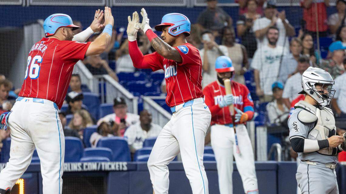 Miami Marlins outfielder Dane Myers (54) celebrates with third base Jake Burger (36) after hitting a home run against the Chicago White Sox in the seventh inning of their MLB game at loanDepot park on Saturday, July 6, 2024, in Miami, Fla.