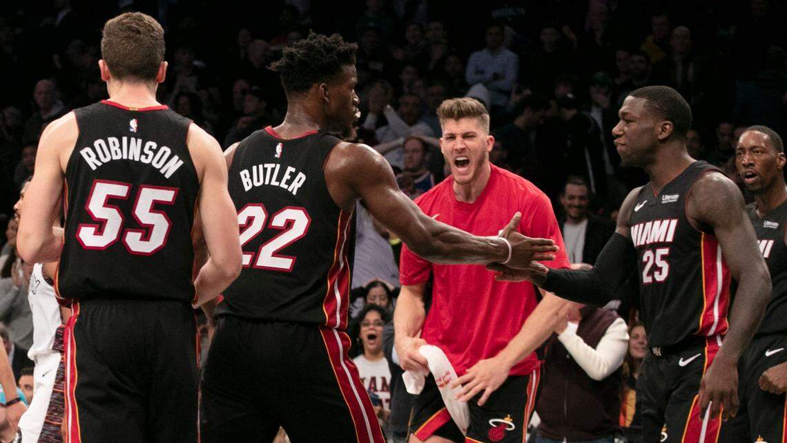 Heat forward Jimmy Butler (22) and guard Kendrick Nunn (25) celebrate after defeating the Brooklyn Nets in an NBA basketball game, Sunday, Dec. 1, 2019 in New York.