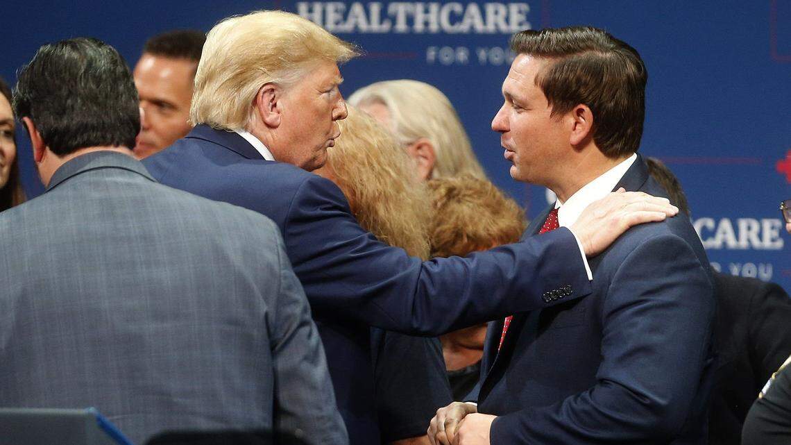 In 2019 image, then-President Donald Trump talks to Florida Gov. Ron DeSantis after giving a speech in The Villages, Florida. They now are rivals.