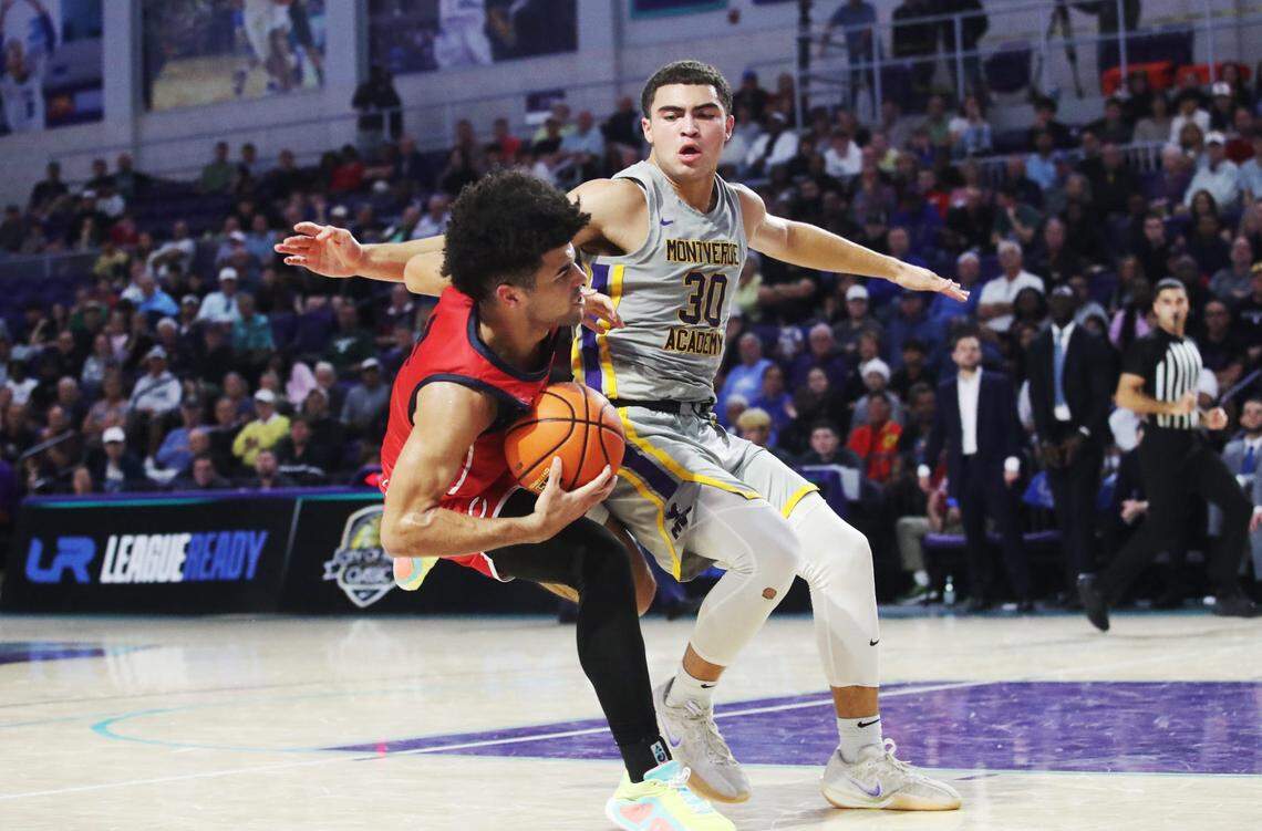 Cayden Boozer of the Miami Columbus High School basketball team drives to the basket during the championship game against Montverde at the City of Palms Classic at Suncoast Credit Union Arena in Fort Myers on Monday, Dec. 23, 2024. He is defended by Dante Allen of Montverde Academy. Miami Columbus won.