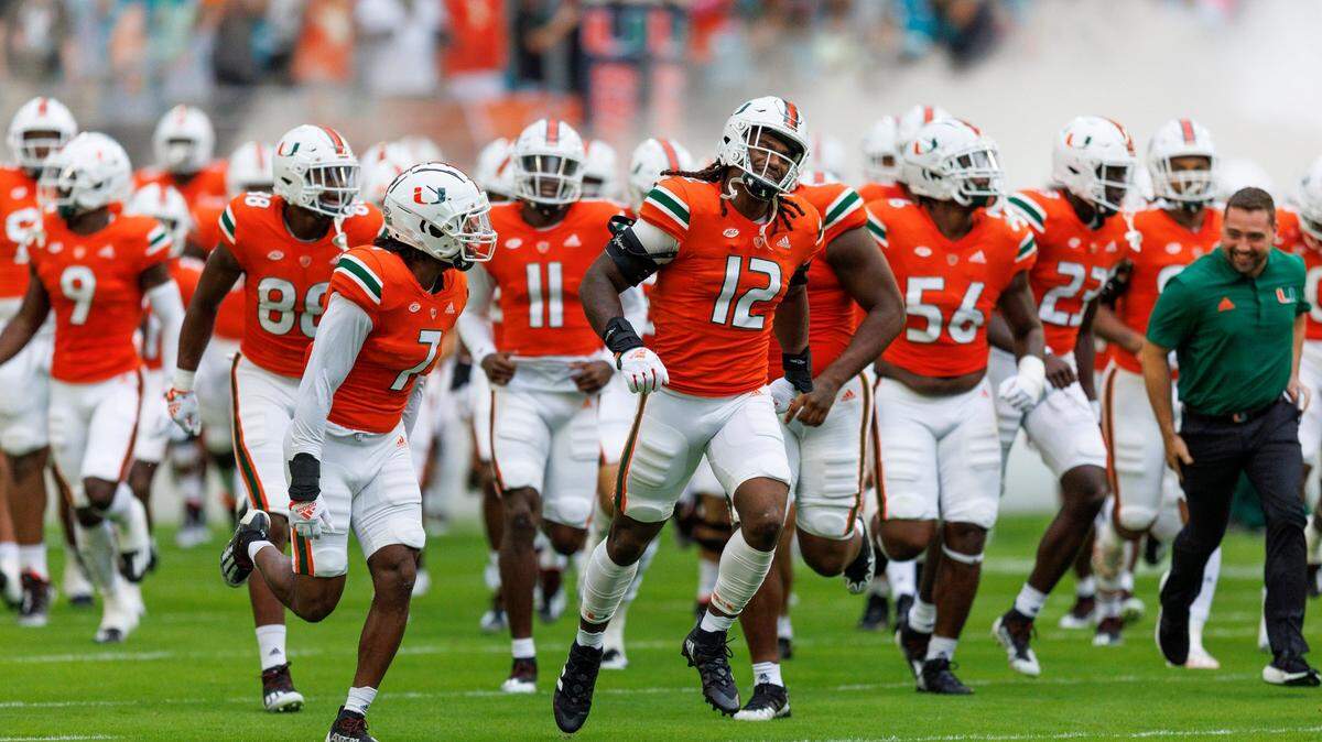 Miami Hurricanes defensive lineman Jahfari Harvey (12) take the field with teammates before the start of an ACC conference football game against North Carolina Tar Heels at Hard Rock Stadium on Saturday, October 8, 2022 in Miami Gardens, Florida..