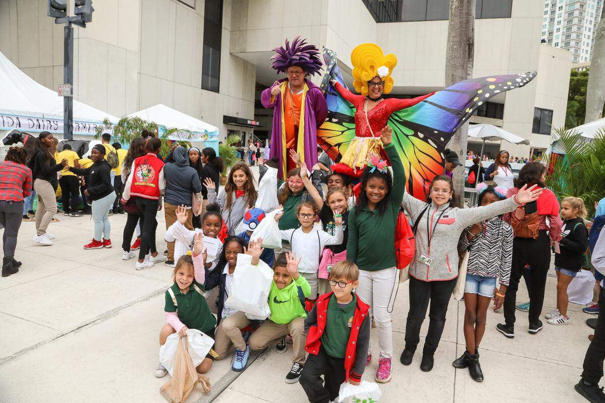 Stiltwalkers with kids at Children’s Alley.