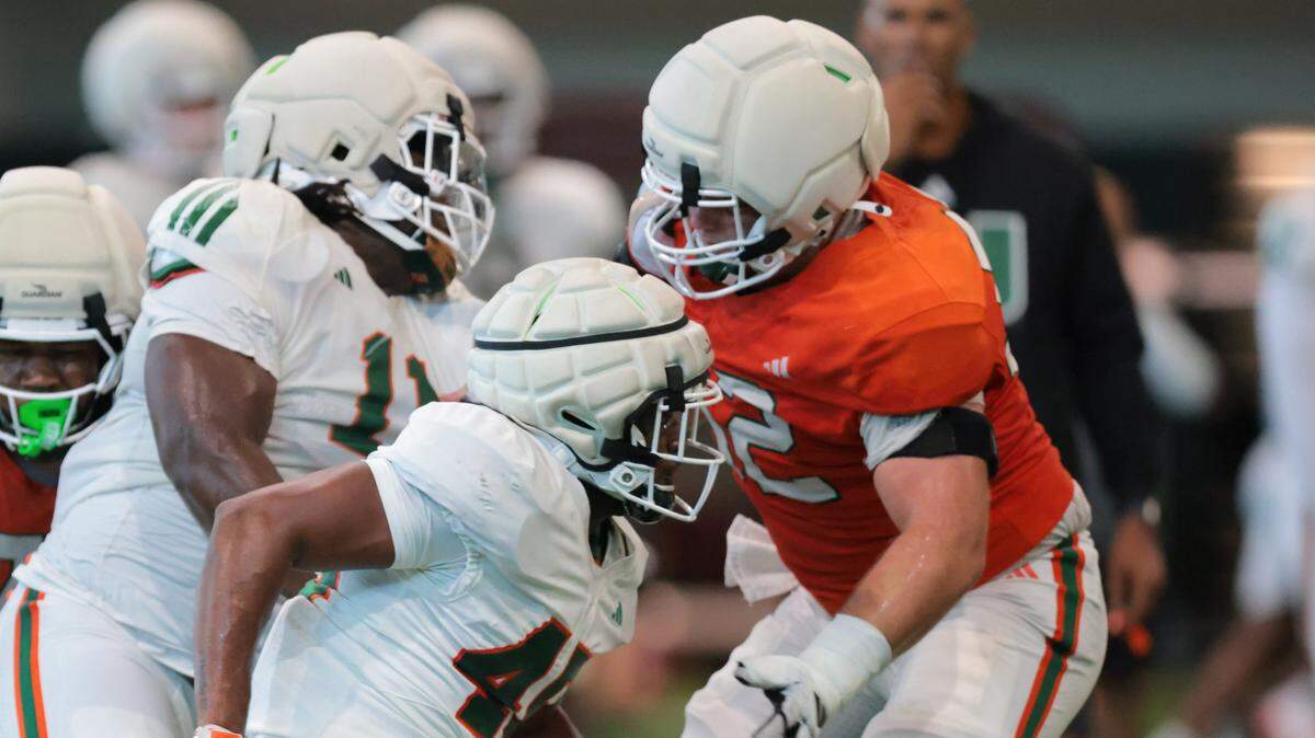 Miami Hurricanes linebacker Braylon Lamar (45) works with offensive lineman James Brockermeyer (52) during football practice at the Carol Soffer Indoor Practice Facility at the University of Miami in Coral Gables, Florida, on Thursday, Aug. 7, 2025.
