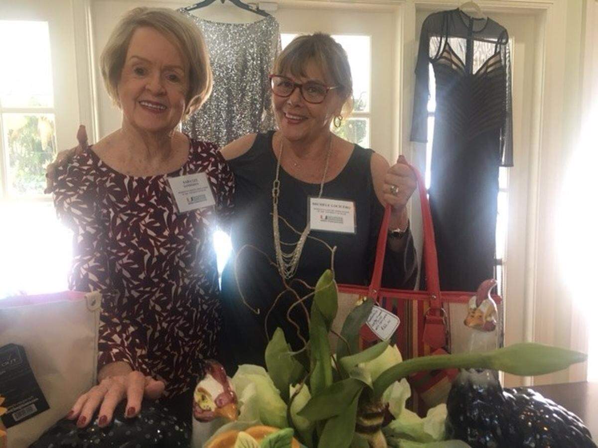 Sara Lee Sanderson and Michele Locicero get ready for the annual Ultimate Bazaar hosted by the Woman’s Cancer Association of the University of Miami.