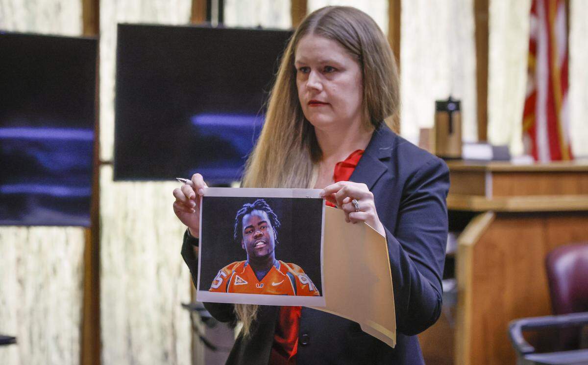 Assistant State Attorney Cristina Diamond shows the jury a photograph of Bryan Pata during the trial of Rashaun Jones, who is accused of killing his University of Miami football teammate Bryan Pata in 2006. Judge Cristina Miranda presiding in Courtroom 4-1 at the Richard E. Gerstein Justice Building on Wednesday, February 18, 2026.
