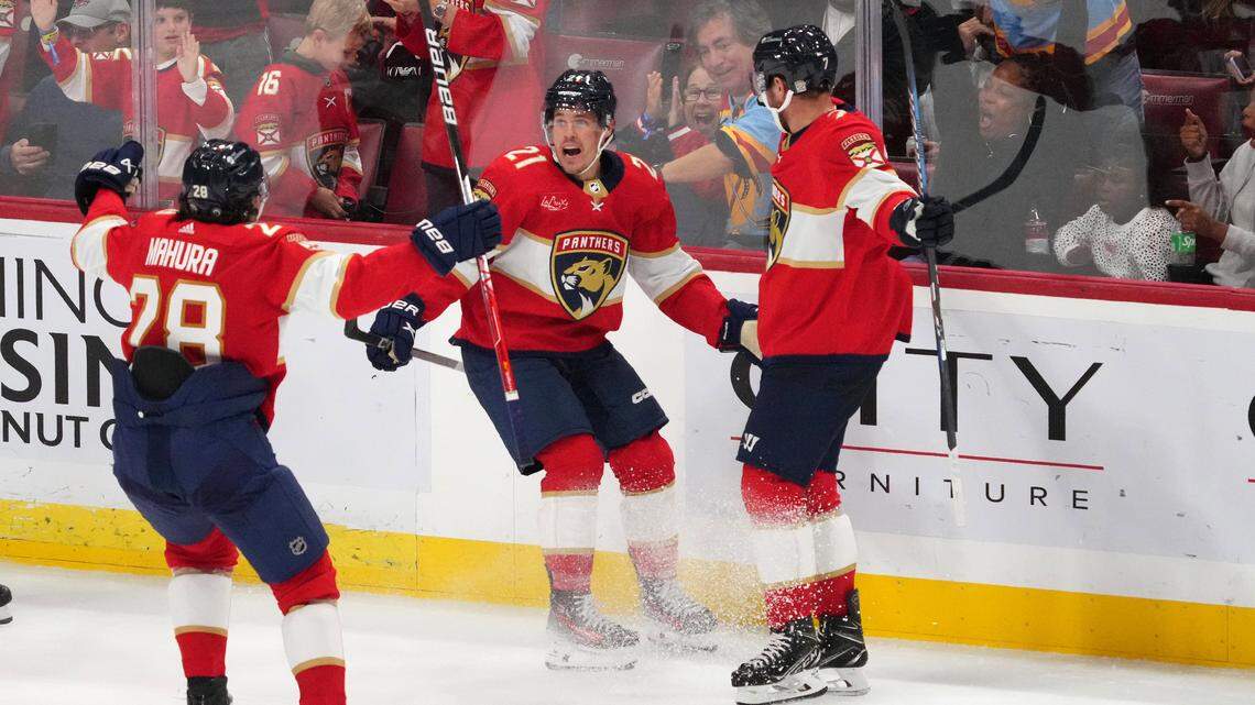 Oct 28, 2023; Sunrise, Florida, USA; Florida Panthers center Nick Cousins (21) celebrates his goal against the Seattle Kraken with defenseman Josh Mahura (28) and defenseman Dmitry Kulikov (7) during the third period at Amerant Bank Arena.