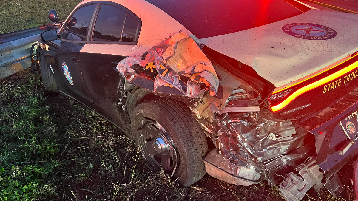 A Florida Highway Patrol cruiser is crashed into the median on I-75 in Weston Tuesday, Jan. 2, 2024, after a Porsche crashed into the back of the car, injuring the trooper.
