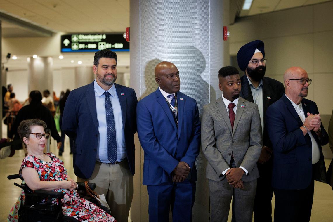Dimas Lipiz, RouteMe CEO and co-founder, second from left, Pierre Paul, North American Partnerships Strategist for Signapse, third from right, and Param Nagpal, CEO of Mapsted, second from right, listen to the announcement that they won a tech challenge to bring new technology driven by artificial intelligence to MIA on Thursday, Aug. 15, 2024, at Miami International Airport in Miami, Fla.