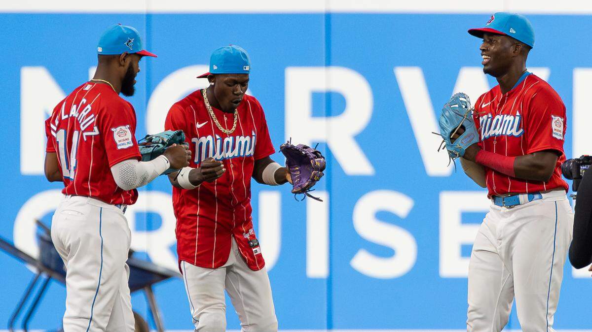 Miami Marlins left fielder Bryan De La Cruz (14), center fielder Jazz Chisholm Jr. (2) and right fielder Jesus Sanchez (7) celebrate after defeating the Chicago Cubs 7 to 6 during their MLB game at loanDepot park on Saturday, April 29, 2023, in Miami, Fla.