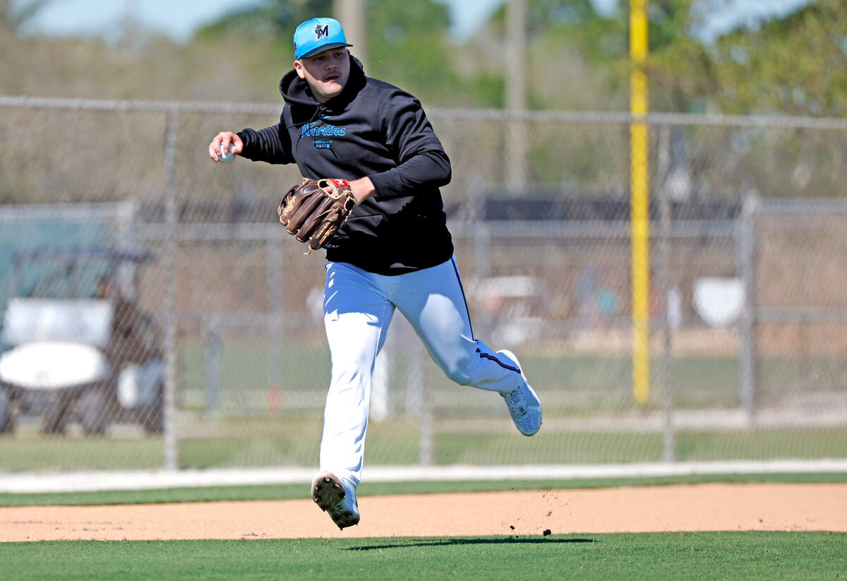 Miami Marlins third baseman Jake Burger looks to throw to first base during spring training at Roger Dean Chevrolet Stadium in Jupiter, Florida on Tuesday, February 20, 2024.
