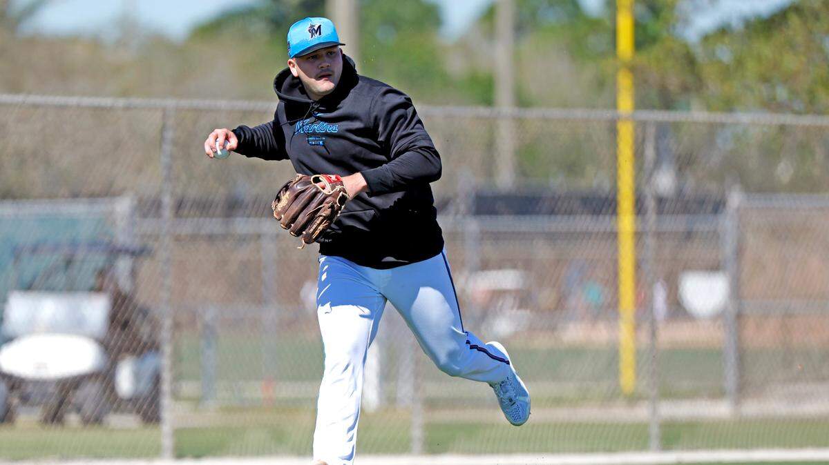 Miami Marlins third baseman Jake Burger looks to throw to first base during spring training at Roger Dean Chevrolet Stadium in Jupiter, Florida on Tuesday, February 20, 2024.