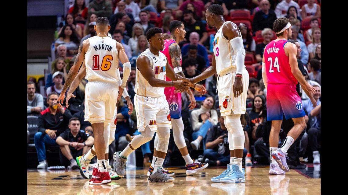 Miami Heat point guard Kyle Lowry (7) reacts with center Bam Adebayo (13) during the first quarter of an NBA game against the Washington Wizards at FTX Arena in Downtown Miami, Florida, on Wednesday, November 23, 2022.