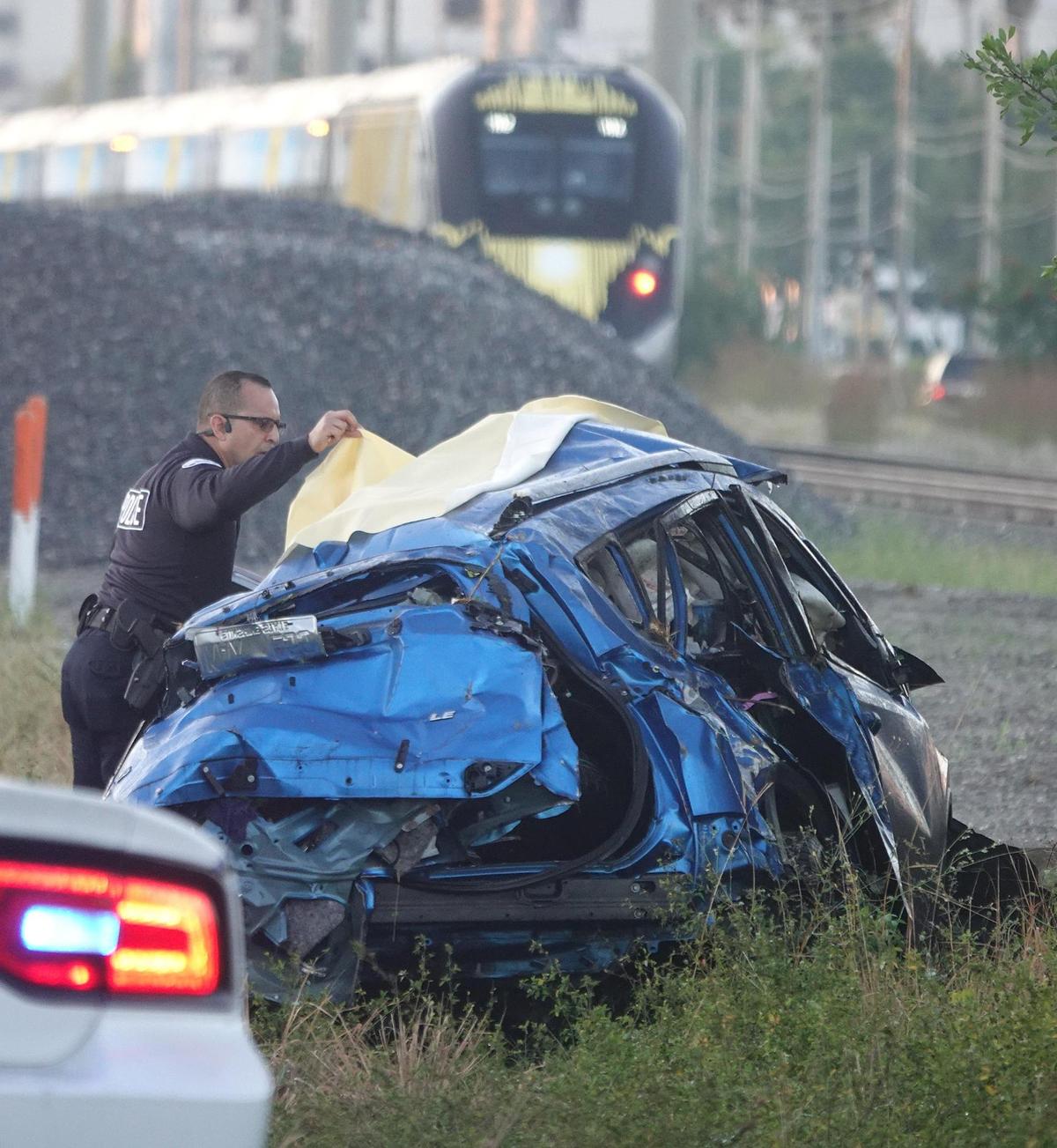Aventura Police Department traffic homicide investigators look over a Brightline train crash that left two dead on Thursday Dec. 30, 2021.