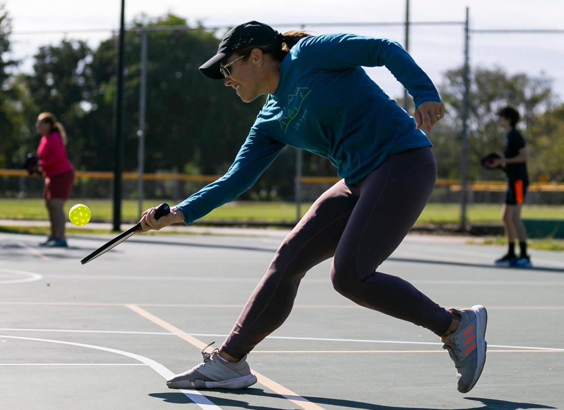 Maria Elena Guinand, 57, plays a game of pickleball at Suniland Park in Pinecrest, Florida on Friday, January 14, 2022.