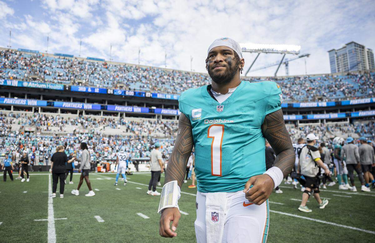 Miami Dolphins quarterback Tua Tagovailoa (1) makes his way off the field after losing to the Carolina Panthers in their NFL game at the Bank of America Stadium on Sunday, Oct. 5, 2025, in Charlotte, N.C.
