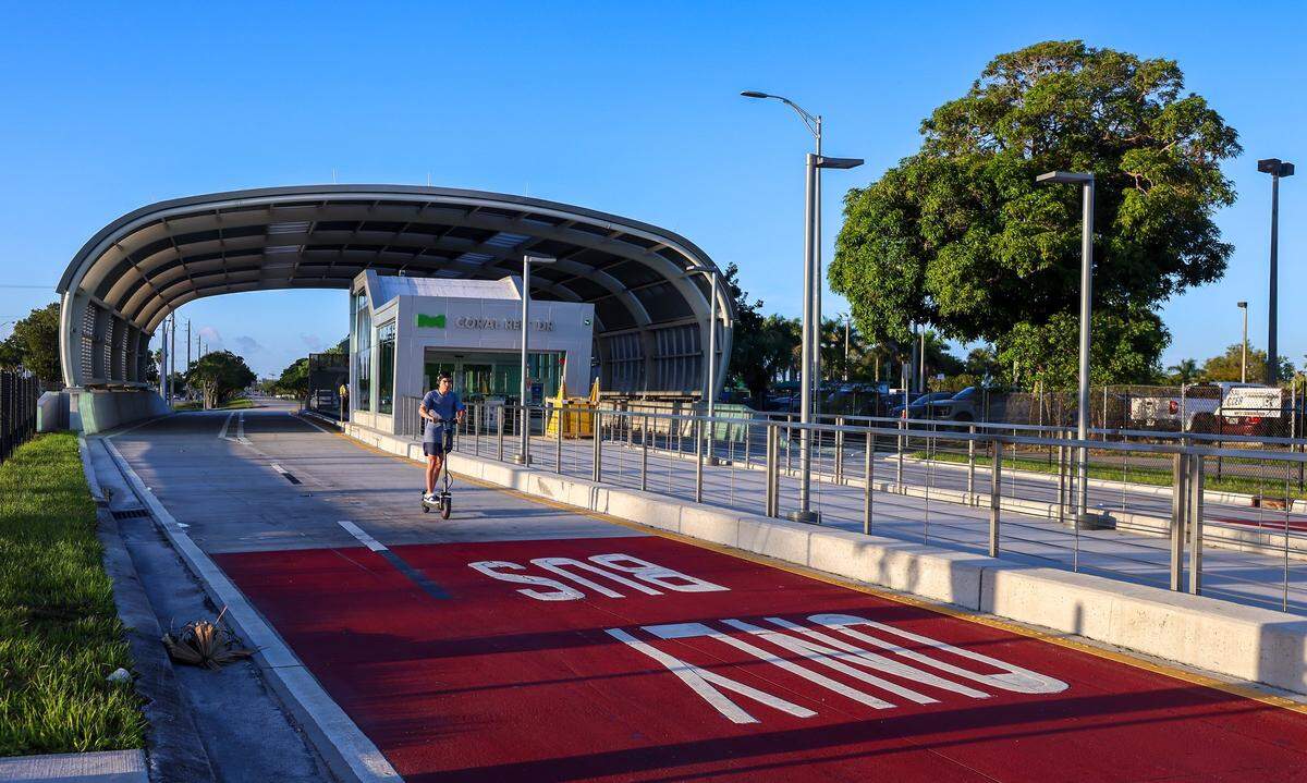 An unidentified electric scooter operator illegally uses the express bus lane on the first day of Miami-Dade's $300 million rapid-transit bus line known as “Metro Express” on Monday, October 27, 2025, at the 152 Street Station just west of Richmond Heights on Coral Reef Drive and U.S. 1.  Only buses are allowed in the express lane all other vehicles, pedestrians, and cyclists are prohibited and are subject to fines. 
