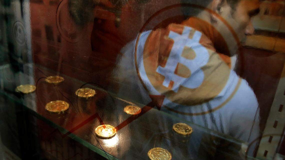 A man uses a Bitcoin ATM in Hong Kong in 2017. Various cryptocurrency scams have bilked $80 million from more than 7,000 people in the United States since October.