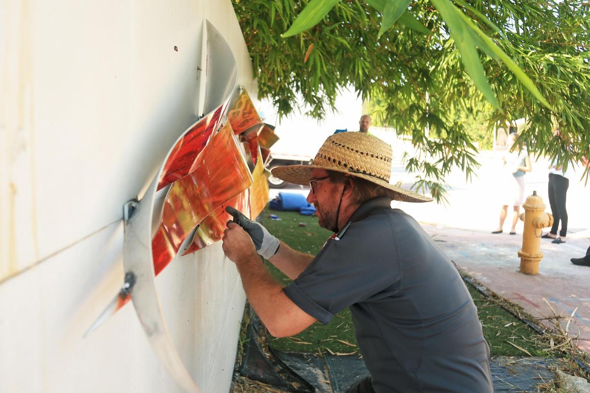 Workers from Museo Vault remove art from the wall of a house at 5101 Pine Tree Drive in Miami Beach on Tuesday.