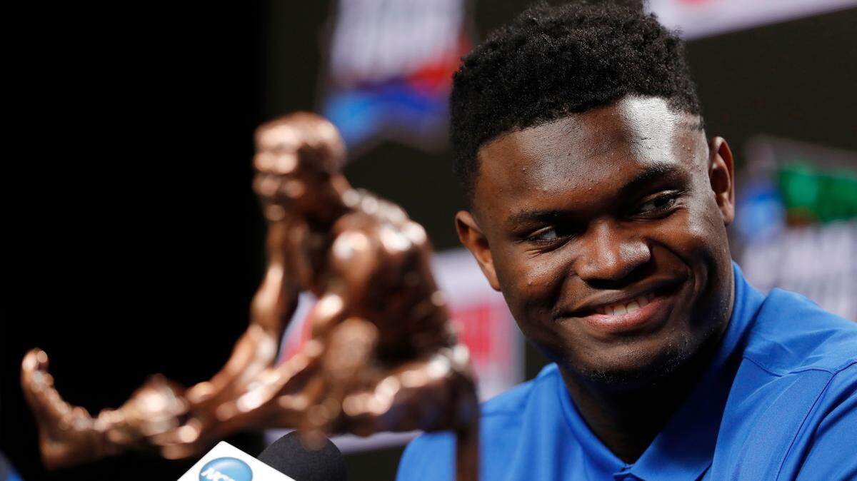 Duke freshman Zion Williamson sits behind the Oscar Robertson Trophy at a news conference where he was awarded the U.S. Basketball Writers Association College Player of the Year award at the Final Four NCAA college basketball tournament, Friday, April 5, 2019, in Minneapolis.