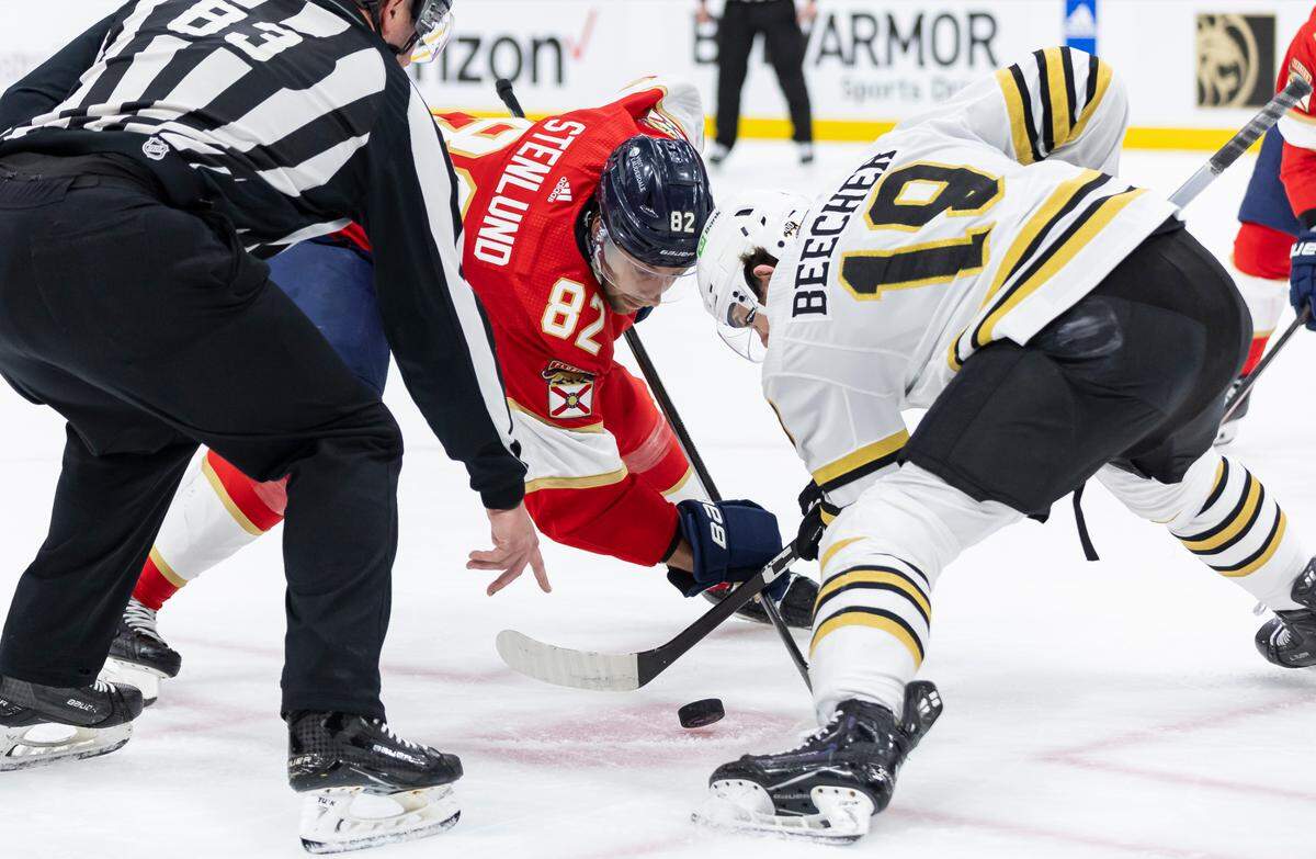 Florida Panthers center Kevin Stenlund (82) and Boston Bruins center John Beecher (19) face-off in the second period of Game 1 of the second-round series of the Stanley Cup Playoffs on Monday, May 6, 2024, in Sunrise, Fla.