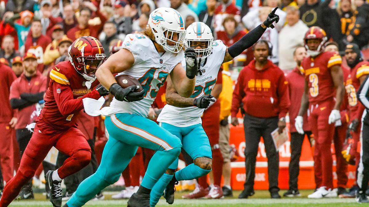 Miami Dolphins linebacker Andrew Van Ginkel (43) runs towards the end zone on an interception as Miami Dolphins cornerback Xavien Howard (25) reacts in the first half against the Washington Commanders at FedEx Field in Landover, Maryland on Sunday, December 3, 2023.