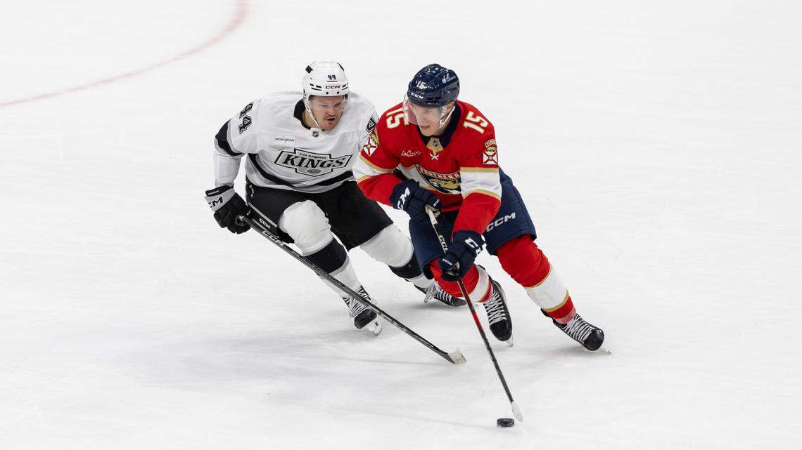 Florida Panthers center Anton Lundell (15) and Los Angeles Kings defenseman Mikey Anderson (44) compete for the puck in the first period of their NHL game at Amerant Bank Arena on Wednesday, Jan. 29, 2025, in Sunrise, Fla.