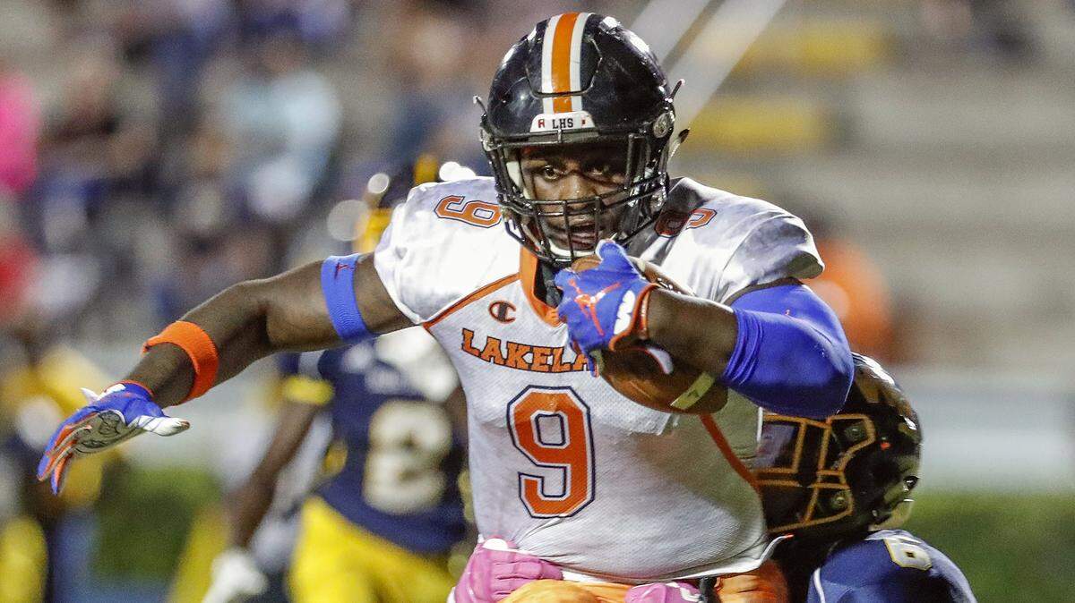 Lakeland TE Keon Zipperer drags Winter Haven defender Jaylen Doles into the end zone as he scores during their Class 7A, District 7 high school football game at Denison stadium in Winter Haven, Florida October 12, 2018. [PIERRE DUCHARME/THE LEDGER]