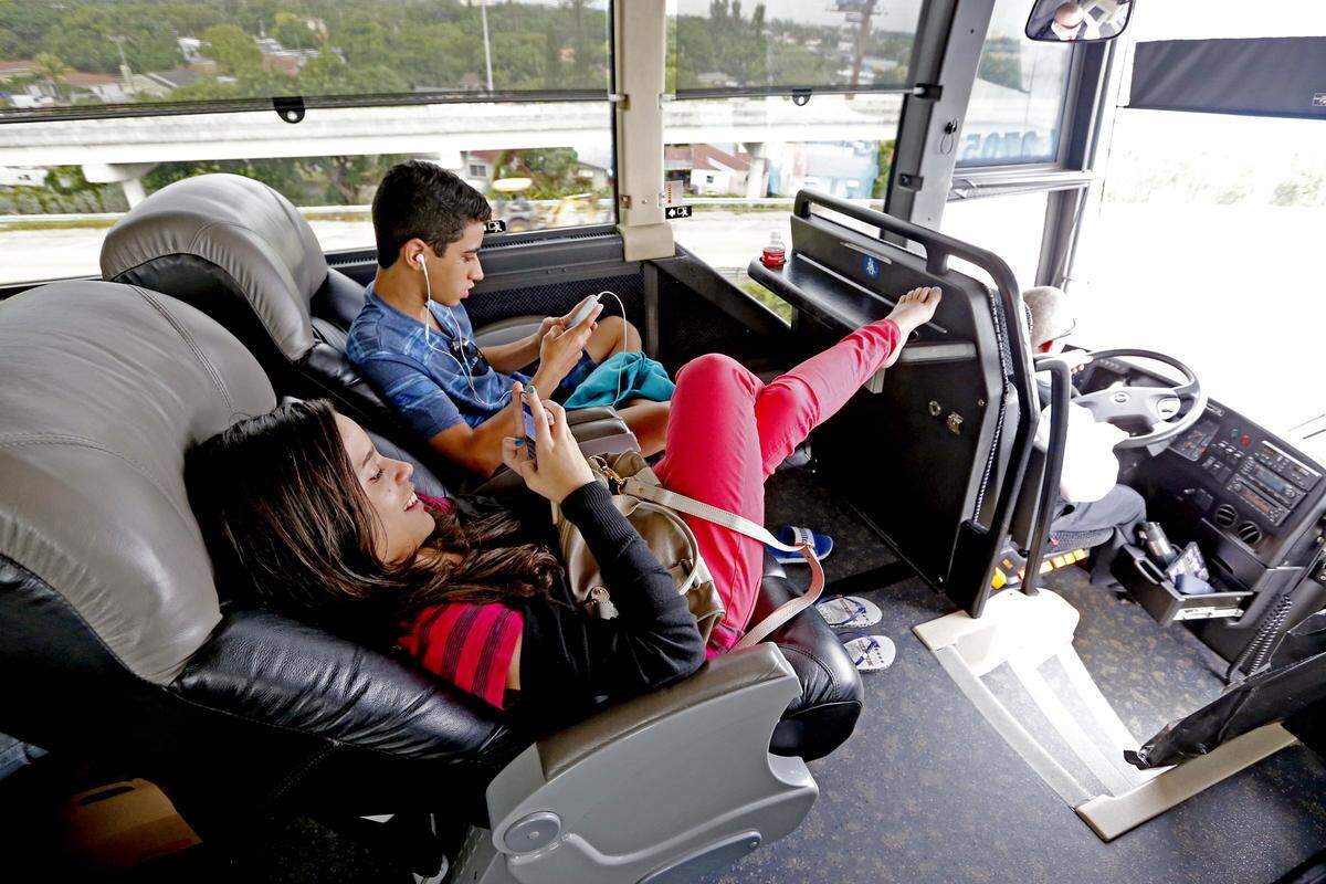 Amanda Oliveiq 14, listens to music as she reclines in her seat on the Red Coach as they travel to Orlando, October 23, 2014.