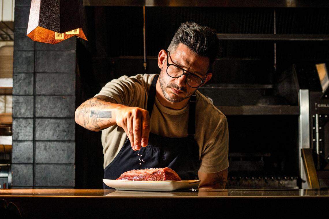 Giorgio Rapicavoli salts a steak at Mayfair Grill, which he’ll take over on Aug. 9.