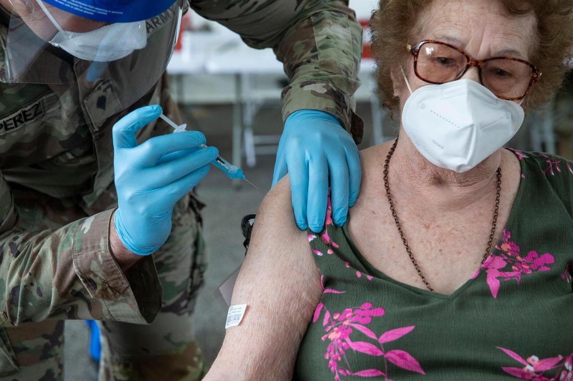 Loida Mendez, 86, is injected with Pfizer’s COVID-19 vaccine during opening day at the FEMA vaccination site on Miami Dade College’s North Campus on Wednesday, March 3, 2021.