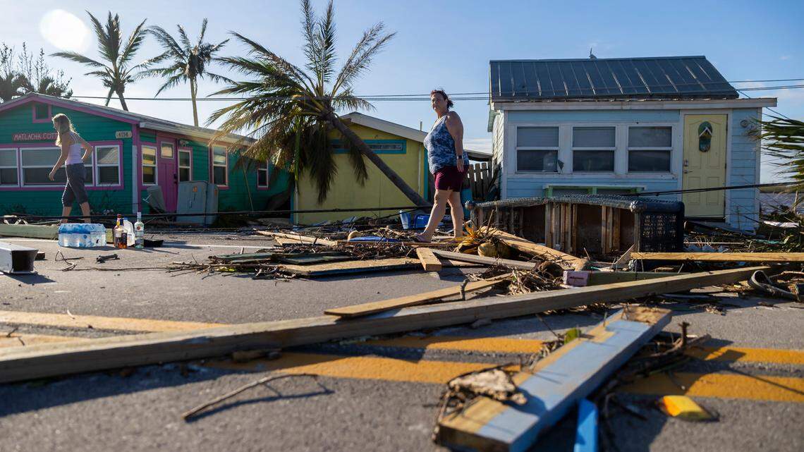 Donna LaMountain, 51, surveys damage on Pine Island Road on Thursday, Sept. 29, 2022, in Matlacha after Hurricane Ian made landfall. The storm has added to the pressure on Florida’s insurance market, with Farmers the latest to say it is leaving the state because of growing risks.