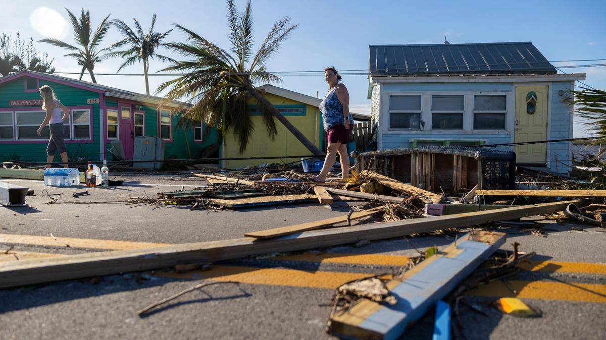 Donna LaMountain, 51, surveys damage on Pine Island Road on Thursday, Sept. 29, 2022, in Matlacha after Hurricane Ian made landfall. The storm has added to the pressure on Florida’s insurance market, with Farmers the latest to say it is leaving the state because of growing risks.