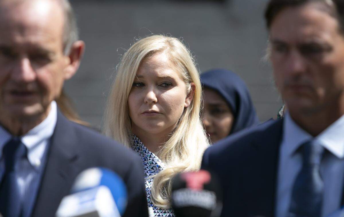 Virginia Roberts Giuffre stands between attorneys David Boies (L) and Brad Edwards (r) during a press conference where Giuffre spoke briefly about the emotional court hearing Tuesday monring for the accusers of Jeffrey Epstein. Approximately two dozen women gathered at a New York City federal courthouse Tuesday, Aug. 27, 2019 to talk about their alleged abuse by Epstein in open court, many speaking for the very first time.