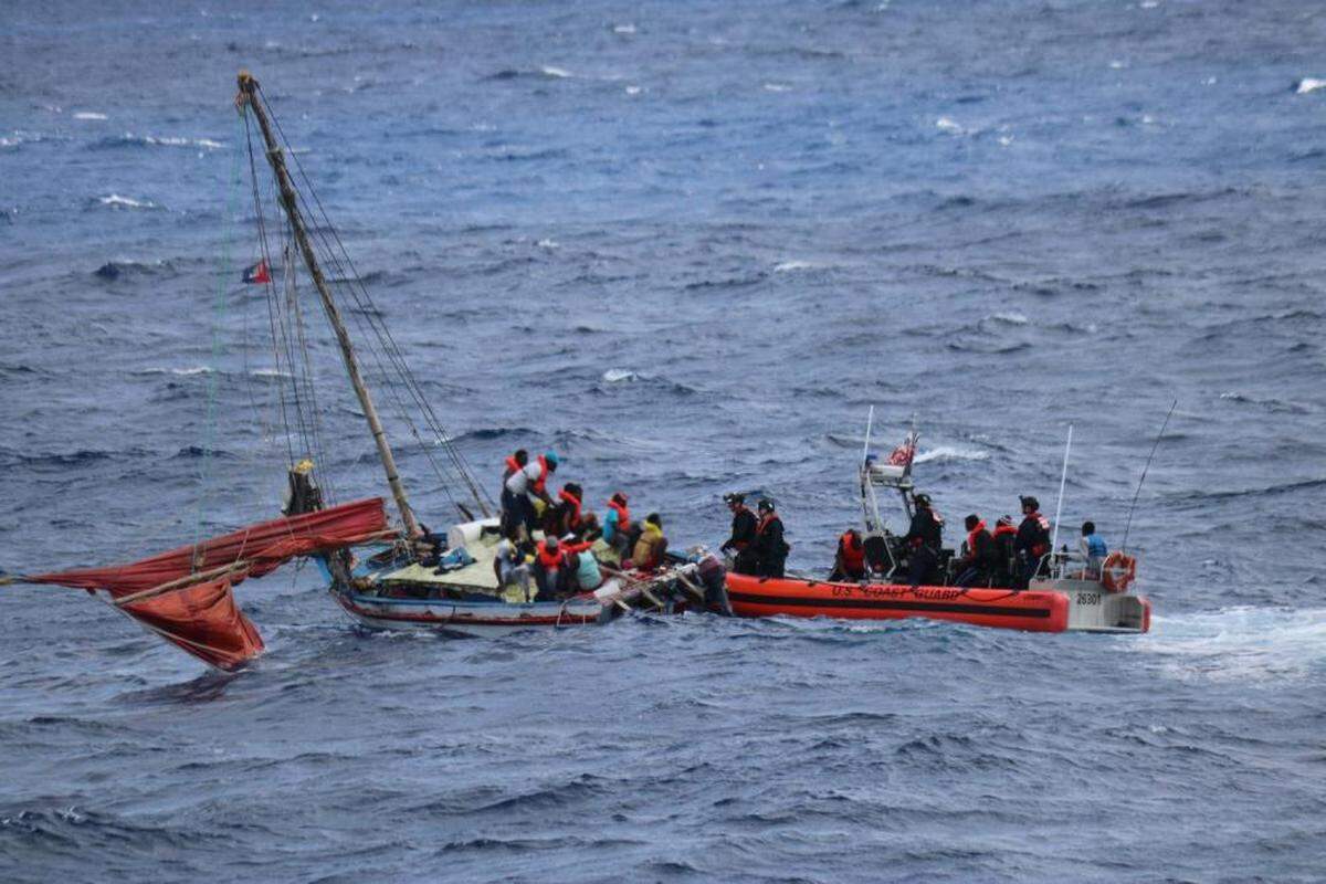Coast Guard Cutter Campbell’s small boat crew stops people aboard an overloaded vessel near Anguilla Cay, Bahamas, April 11, 2022. Coast Guard Cutter Charles Sexton crew transferred the 67 Haitians aboard the overloaded vessel to Bahamian authorities.