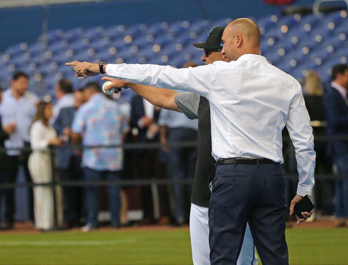 Miami Marlins manager Don Mattingly and Marlins CEO Derek Jeter talk during workout day ahead of Opening Day at the Marlins Park on Wednesday, March 27, 2019 in Miami.