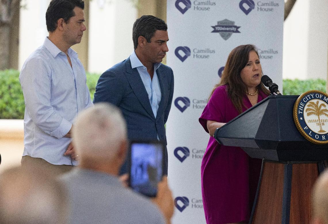 Hilda Fernandez, right, CEO of Camillus House, speaks during a press conference with Miami Mayor Francis Suarez, center, and Commissioner Ken Russell announcing a $2 million city donation to Camillus House as part of the “Functional Zero” homeless plan on Friday, Oct. 14, 2022, in Miami.
