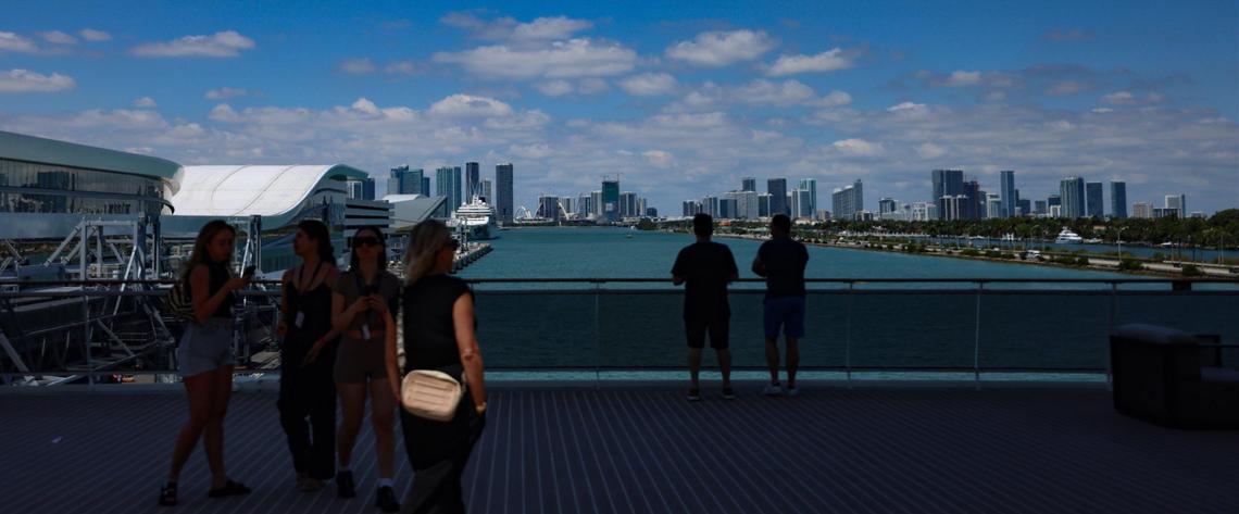 Visitors and travelers take in the view of the Miami skyline from MSC World America at PortMiami.