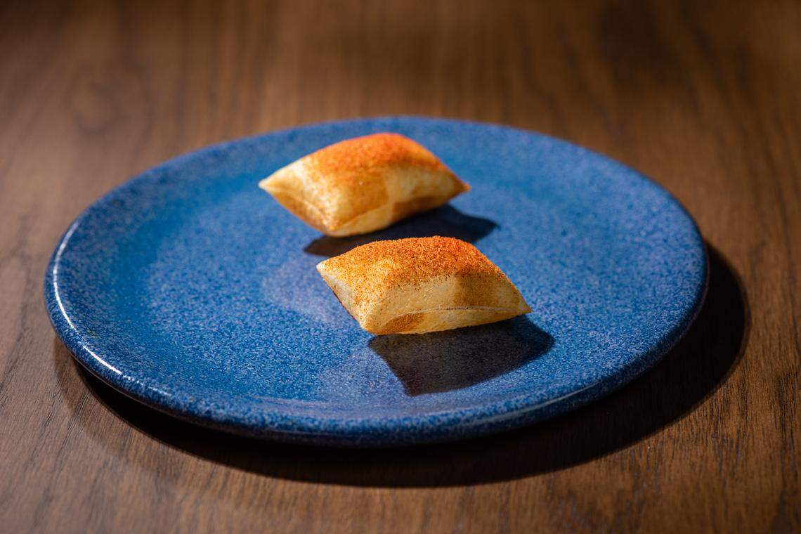 Pommes Souffle, the first bite on the tasting menu at Lion & The Rambler, was inspired by Zapp’s Voodoo Chips.