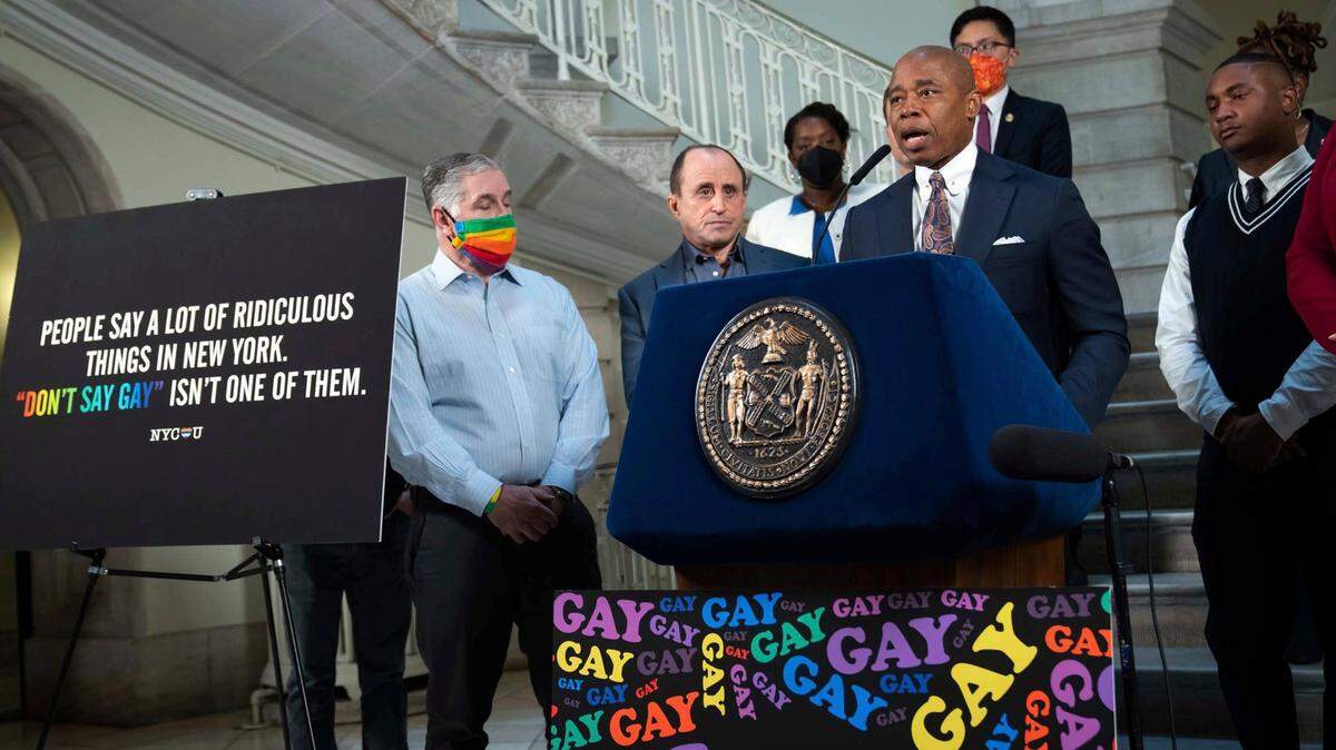 New York Mayor Eric Adams, at podium, addresses a news conference in the rotunda of City Hall, in New York, Monday, April 4, 2022. New York City is launching a digital billboard campaign supporting LGBTQ visibility that will be displayed in five major markets in Florida for eight weeks, to lure Floridians unhappy with their state’s “don’t say gay” measure to the Big Apple, Adams announced.