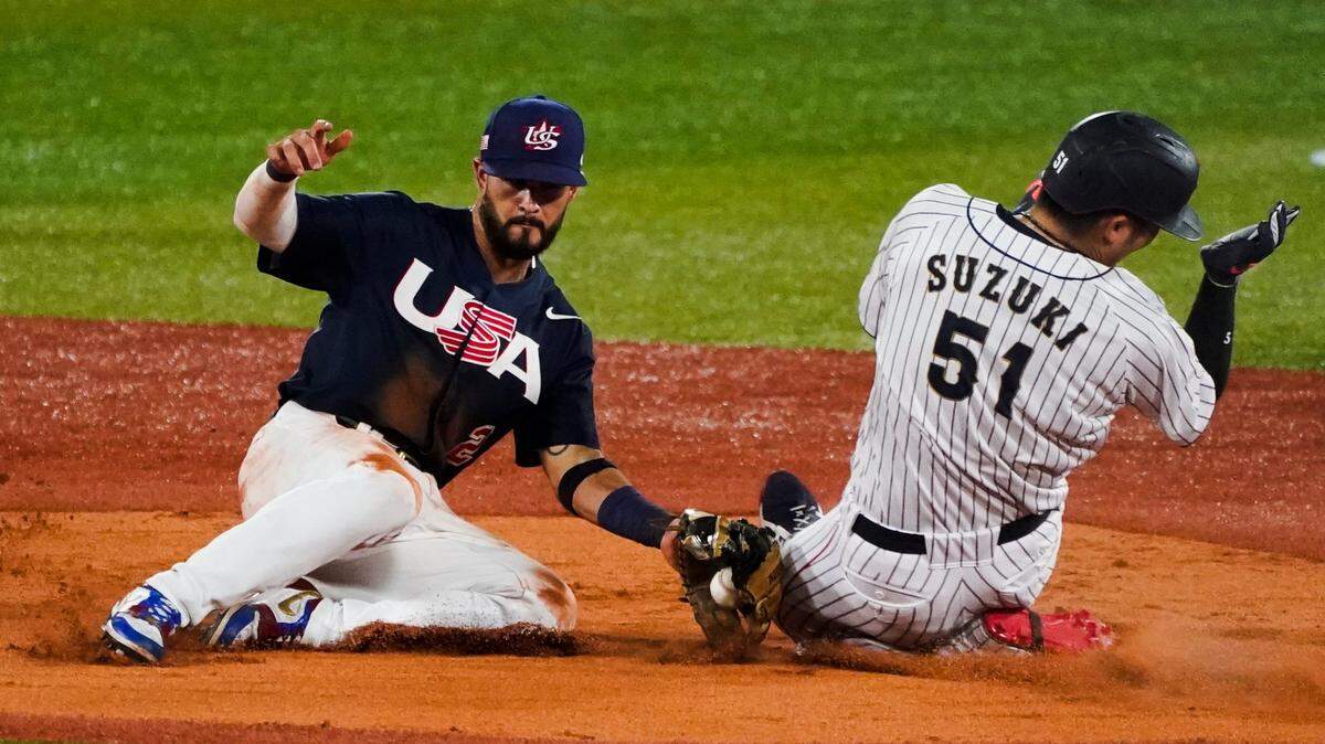 Japan’s Seiya Suzuki (51) is tagged out by United States’ Eddy Alvarez attempting to steal second during the gold medal baseball game at the 2020 Summer Olympics, Saturday, Aug. 7, 2021, in Yokohama, Japan.