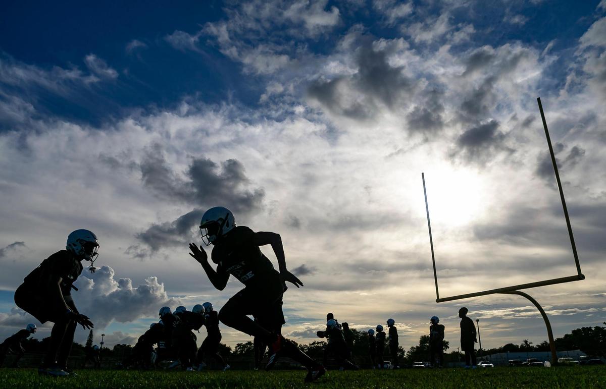 Miami Central football players run drills during a preseason practice at their school’s field in Miami’s West Little River neighborhood on Thursday, August 5, 2021.