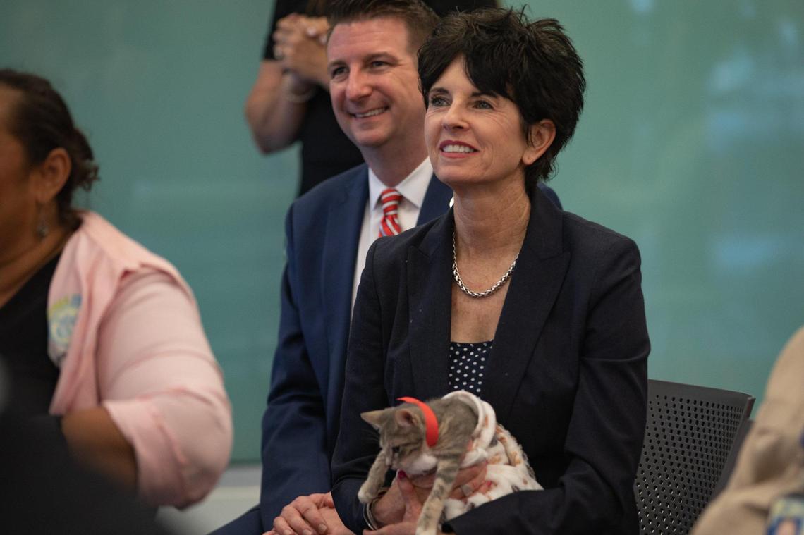 Bronwyn Stanford, Director of Animal Services, listens during a press conference while holding cat Tatiana at the Miami-Dade Animal Services Pet Adoption & Protection Center in Doral, Florida, on Thursday, Dec. 18, 2022.
